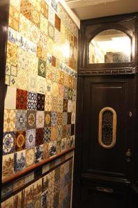 a room with a door and a tile wall at Bed & Breakfast The 9 Streets in Amsterdam +12 photos
