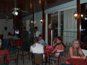 a group of people sitting at tables in a restaurant at Hotel Melike in Kuşadası