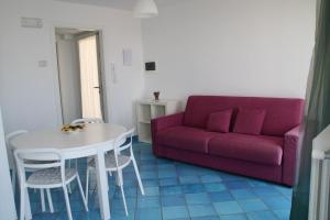 a living room with a red couch and a table at Residenza Sveva in Ravello