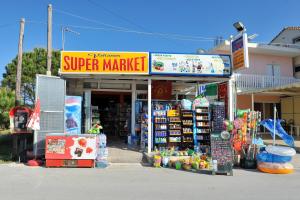 a store with a super market in front of it at Valianos Studios in Alikanas