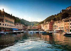 a group of boats in a river with buildings at Clara's House in Portofino