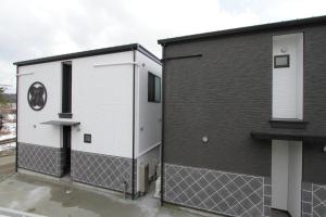 a black and white building with a garage at Fujinokura Village in Fujikawaguchiko
