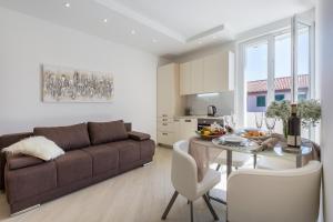 a living room with a couch and a dining room table at Central Boutique Apartments with balconies, in walking distance to the sea in Zadar