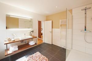 a bathroom with a sink and a shower at Hotel Nordwind in Langeoog