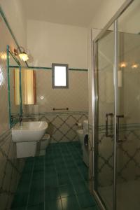 a bathroom with two toilets and a sink and a shower at terrazza metese in Meta