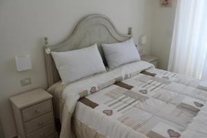 a bedroom with a large bed with white sheets and pillows at B&B Paura in Naples