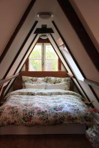 a bed in a room with a window at Bed & Breakfast The 9 Streets in Amsterdam