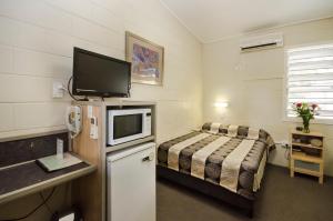 a hotel room with two beds and a television at Biloela Countryman Motel in Biloela