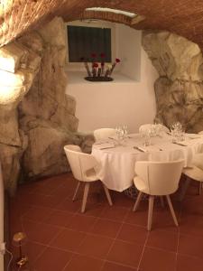 a dining room table and chairs in a room at Sangallo Hotel in Monte San Savino