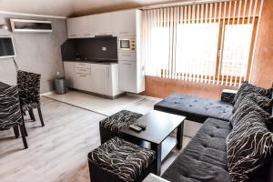 a living room with a couch and a table at Dimitur Jekov Guest House in Obzor