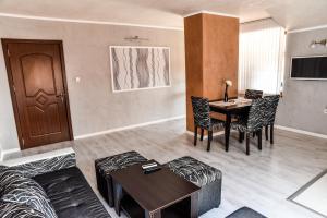 a living room with a couch and a table at Dimitur Jekov Guest House in Obzor