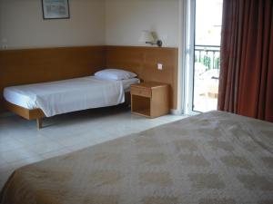 A bed or beds in a room at Summer Memories Aparthotel