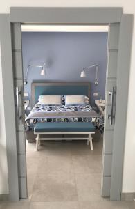 a bedroom with a blue bed with two pillows at Al Parco Primavera B&B in Sorrento