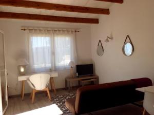 a living room with a couch and a table and a television at Chalet Marivent in Cala'n Bosch