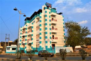 a building with a sign on top of it at Hotel BluRay in Belgaum
