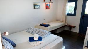 a room with two beds with towels on them at Rosys Little Village in Skala