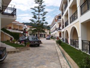 a car parked on a street next to some buildings at Castello Beach Hotel in Argassi