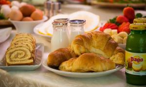 a table with croissants and other breakfast foods at Hotel Centrale in Trieste