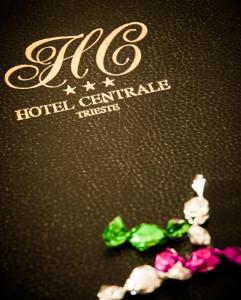 a group of crystals on a table next to a hotel sign at Hotel Centrale in Trieste