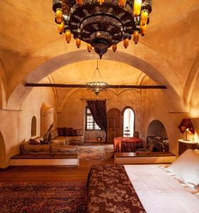 Großes Zimmer mit einem großen Kronleuchter und einem Bett in der Unterkunft Imaret in Kavala