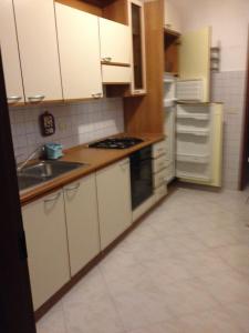 a kitchen with white cabinets and a sink at Foscolomare in Viareggio