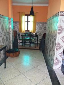 a dining room with a table and a window at Chez Pascal et Nicole in Oualidia +17 photos