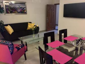 a living room with a table and a couch at Playa a pie Zona Dorada in Mazatlán