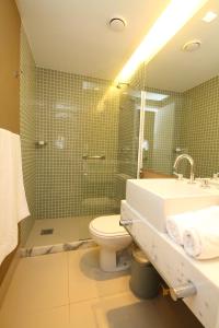 a bathroom with a shower and a toilet and a sink at Link Stay Flats in Rio de Janeiro