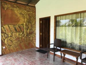 a room with a wall with a painting on it at Shell Resort in Arugam Bay