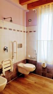 a bathroom with a toilet and a sink and a window at Locanda Avanguardia in Solferino +82 photos