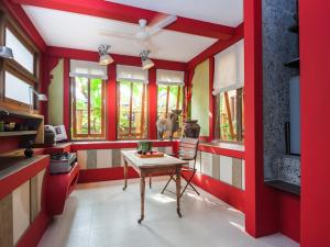 a red kitchen with a table in a room at Maruti Lane Villa in Ubud +17 photos