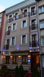 a large tan building with windows and a balcony at Blue Istanbul Hotel in Istanbul