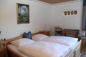a bedroom with two beds and a picture on the wall at Pension Mühlbauer in Lam