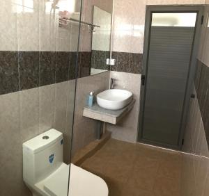 a bathroom with a toilet and a sink and a shower at Luxe Exotica Apartments in La Gaulette