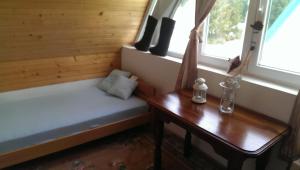 a room with a bed and a table and windows at Holiday Home Stella in Žabljak +7 photos