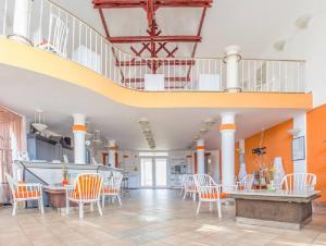 a lobby with orange and white chairs and a staircase at Luna Apartman501 in Siófok