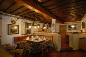 a dining room with a wooden table and chairs at Villa Salis in Altaussee