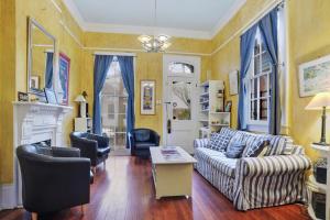 a living room with a couch and chairs and a fireplace at The Burgundy Bed and Breakfast in New Orleans