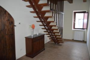 a staircase in a room with a vase of flowers at B&B Il Vicoletto in LʼAquila