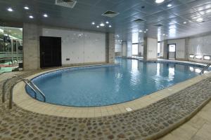 a large swimming pool in a large building at Awaliv Hotel in Taif