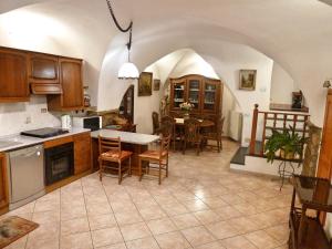 a kitchen and dining room with a table and chairs at Casa Mamma Rosetta in Civezza