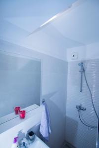 a bathroom with a shower and a white sink at Rooms Megi in Dubrovnik