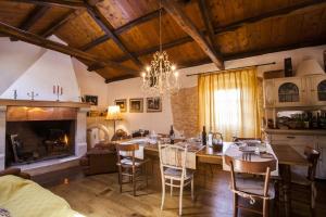 a living room with a dining table and a fireplace at Casa Vecia in Brtonigla