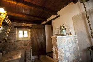 a bathroom with a tub and a sink and a mirror at Casa Vecia in Brtonigla +78 photos