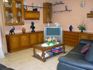 
a living room filled with furniture and a tv at Hotel Francisco Javier in A Coruña
