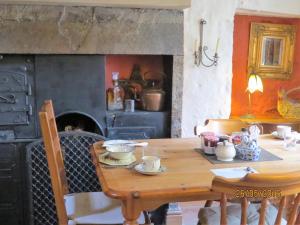 a kitchen with a wooden table and an oven at Eastview Bed and Breakfast in Garrigill