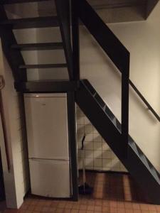 a staircase in a room with a vaulted ceiling at Bed & Breakfast Klokgaaf in De Koog