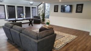 a living room with a couch and a table at Lily's Lodge in West Springfield
