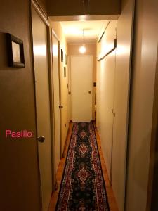 a corridor of a hallway with a rug on the floor at Condominio Matta Torre 1 in Temuco