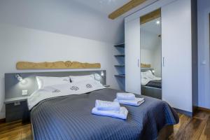 ein Schlafzimmer mit einem Bett mit zwei Handtüchern darauf in der Unterkunft Apartament Tatrzanski Raj in Zakopane